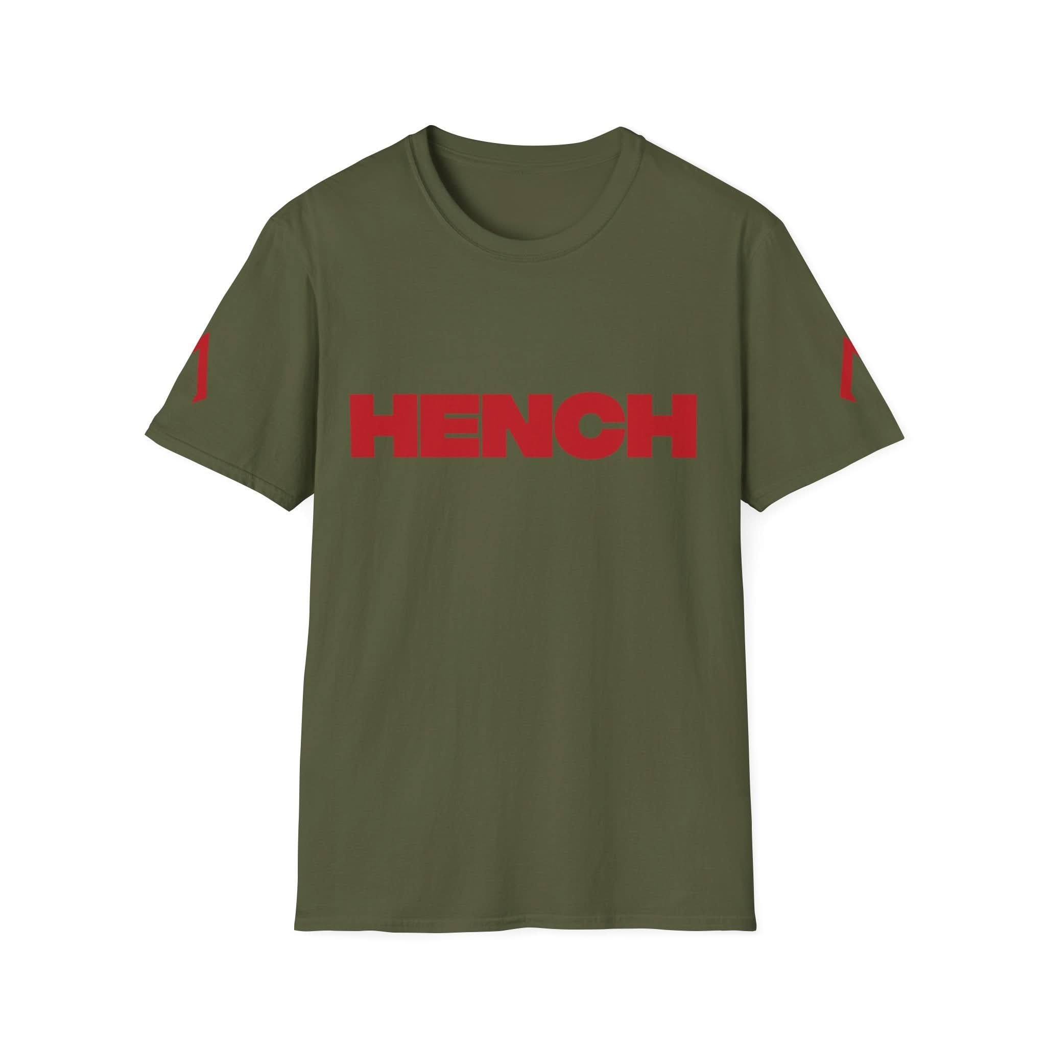 A flat lay image of a Military Green softstyle T Shirt is displayed. The Softstyle Tee with the slogan "Hench" on is prominently featured on the front in bold lettering. This shirt is part of active wear women collections, designed for comfort and style during workouts. Known for its affordability, it's listed among cheap soft t shirts. Ideal for team uniforms or promotional items, you can order t shirts for business in this stylish and versatile design.