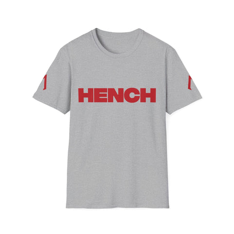 A flat lay image displays a Sport grey softstyle tee. The shirt is a Softstyle Tee with the slogan "Hench" on the front in bold lettering. It is part of womens gym wear, designed for comfort and style during workouts. This tee is also suitable for those needing quick tee shirts for everyday use. Additionally, it can be considered among the ideal t shirts for my business due to its versatile and appealing design.