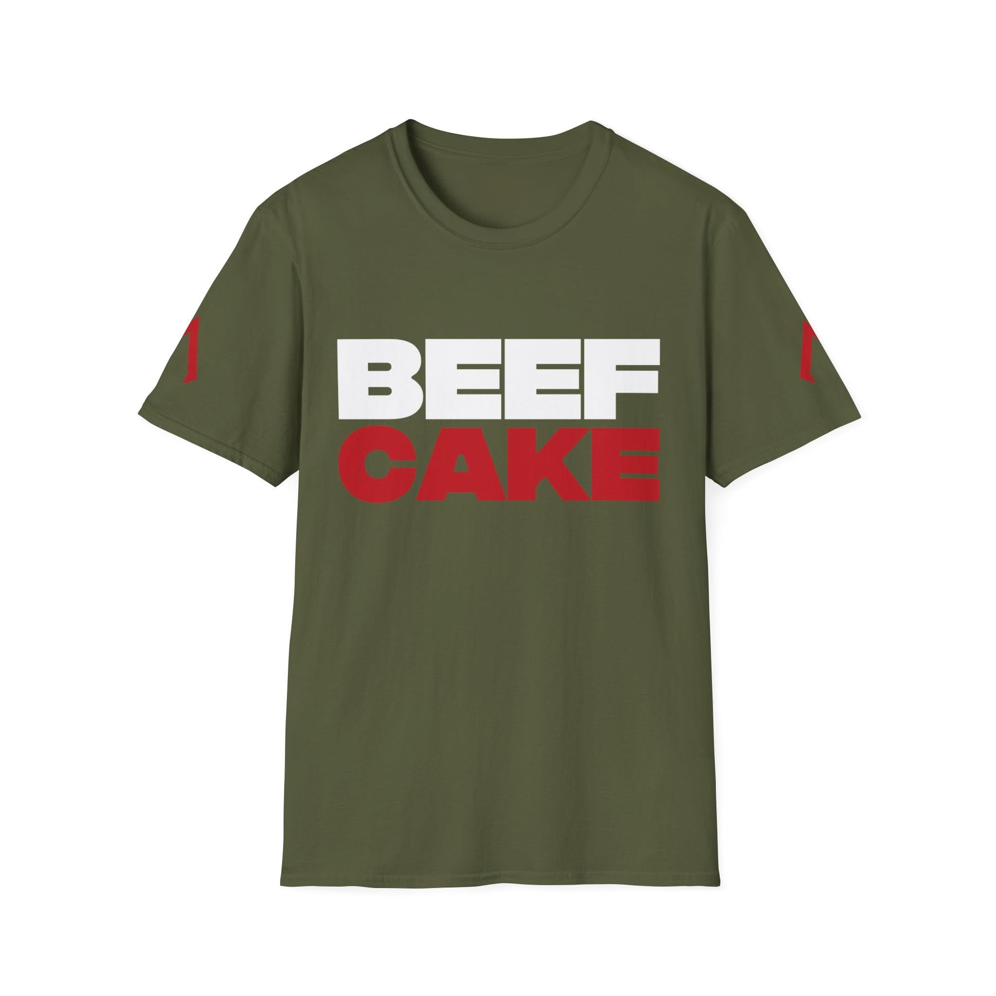 The image shows a military green softstyle t-shirt with a bold design. The text “BEEF CAKE” is printed in large capital letters, with “BEEF” in white and “CAKE” in red. The shirt also features red vertical stripes on both sleeves. This t-shirt is ideal as one of the best gym tees, suitable for women’s exercise shirts, and serves as a gym full shirt.